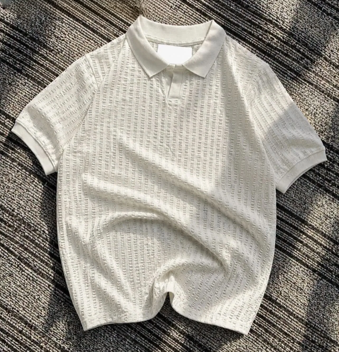White textured knit polo flat lay